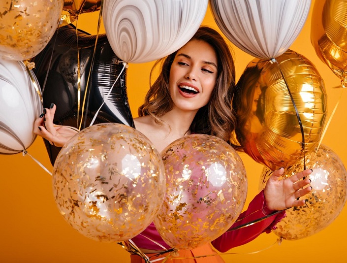 cheerful girl preparing party merry female model holding sparkle balloons