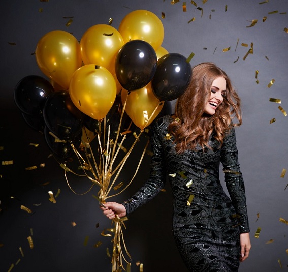 joyful woman with bunch balloons